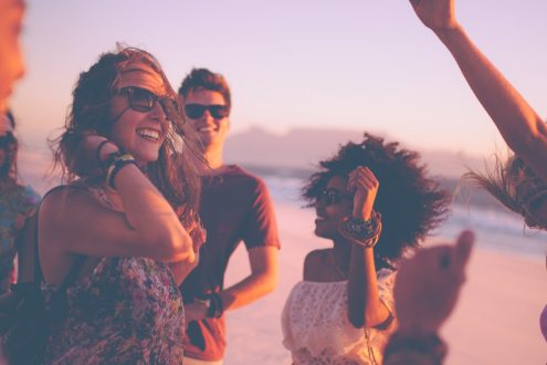 friends-dancing-at-a-summer-sunset-beachparty-picture-id475284976